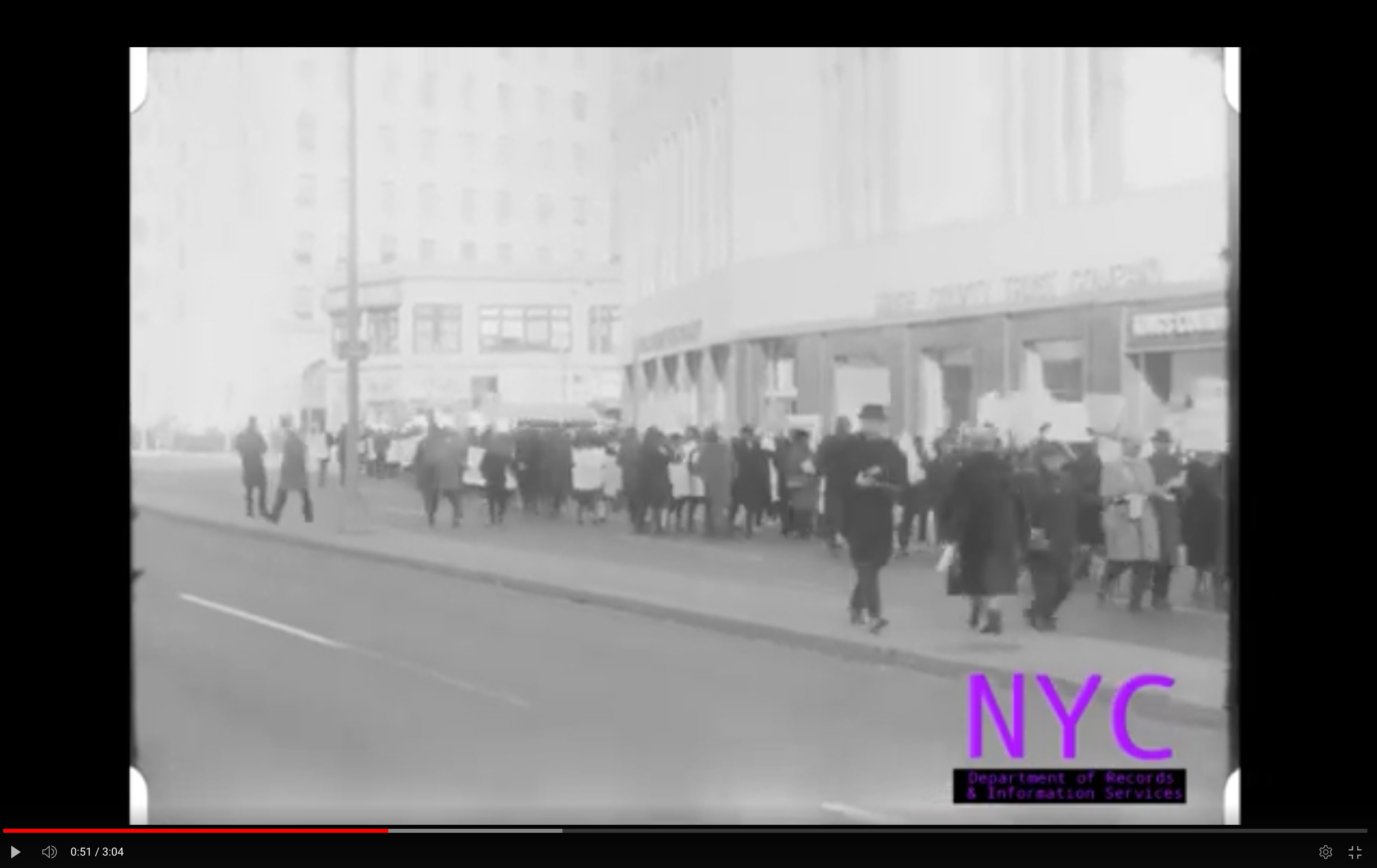 Black school boycotters holding signs in a protest march in downtown Brooklyn.