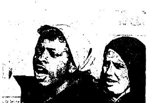 Two young people sing at a protest